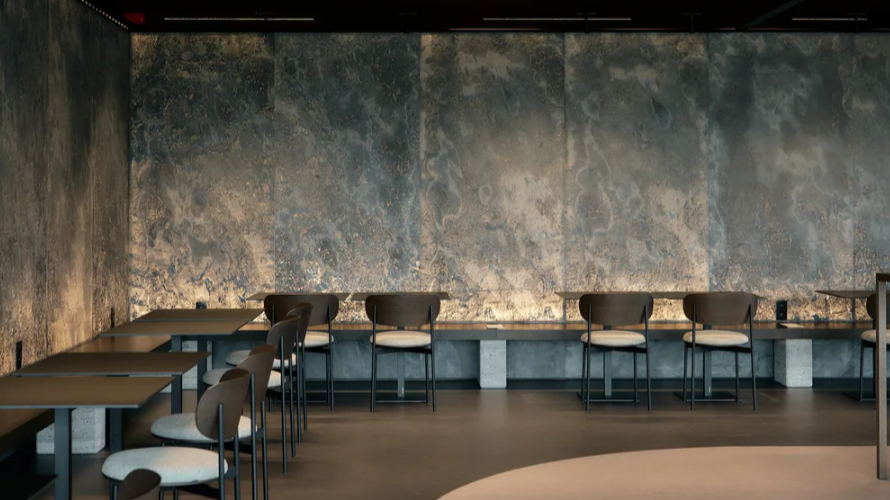 De steenfineerwand en het donkere plafond bepalen mee de sobere uitstraling van de eetruimte