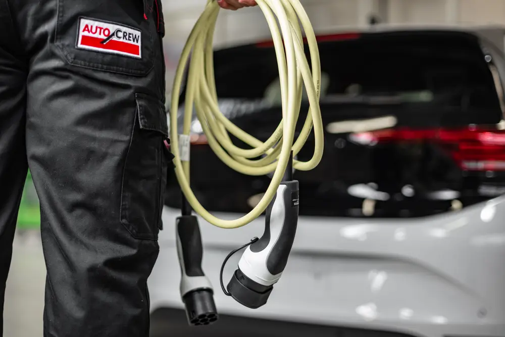 Bosch opleiding EV: man houdt oplaadkabel vast