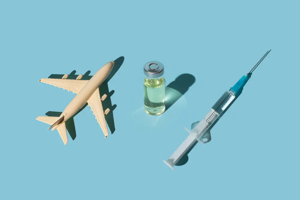 Illustration d'un avion, une dose de vaccin et une seringue pour la vaccination de voyage