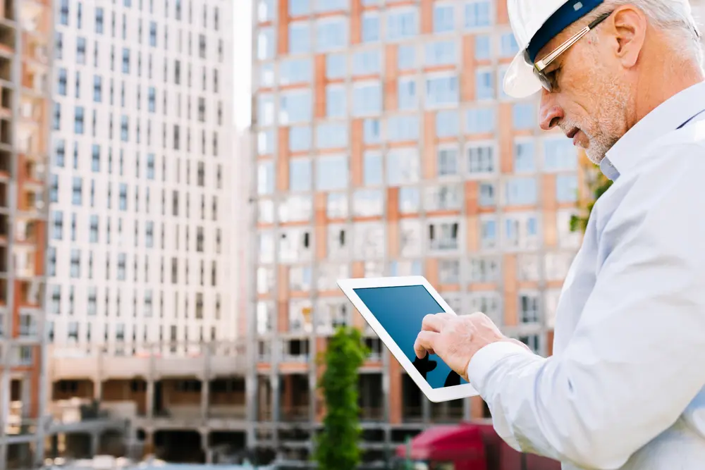 side view old man looking at tablet